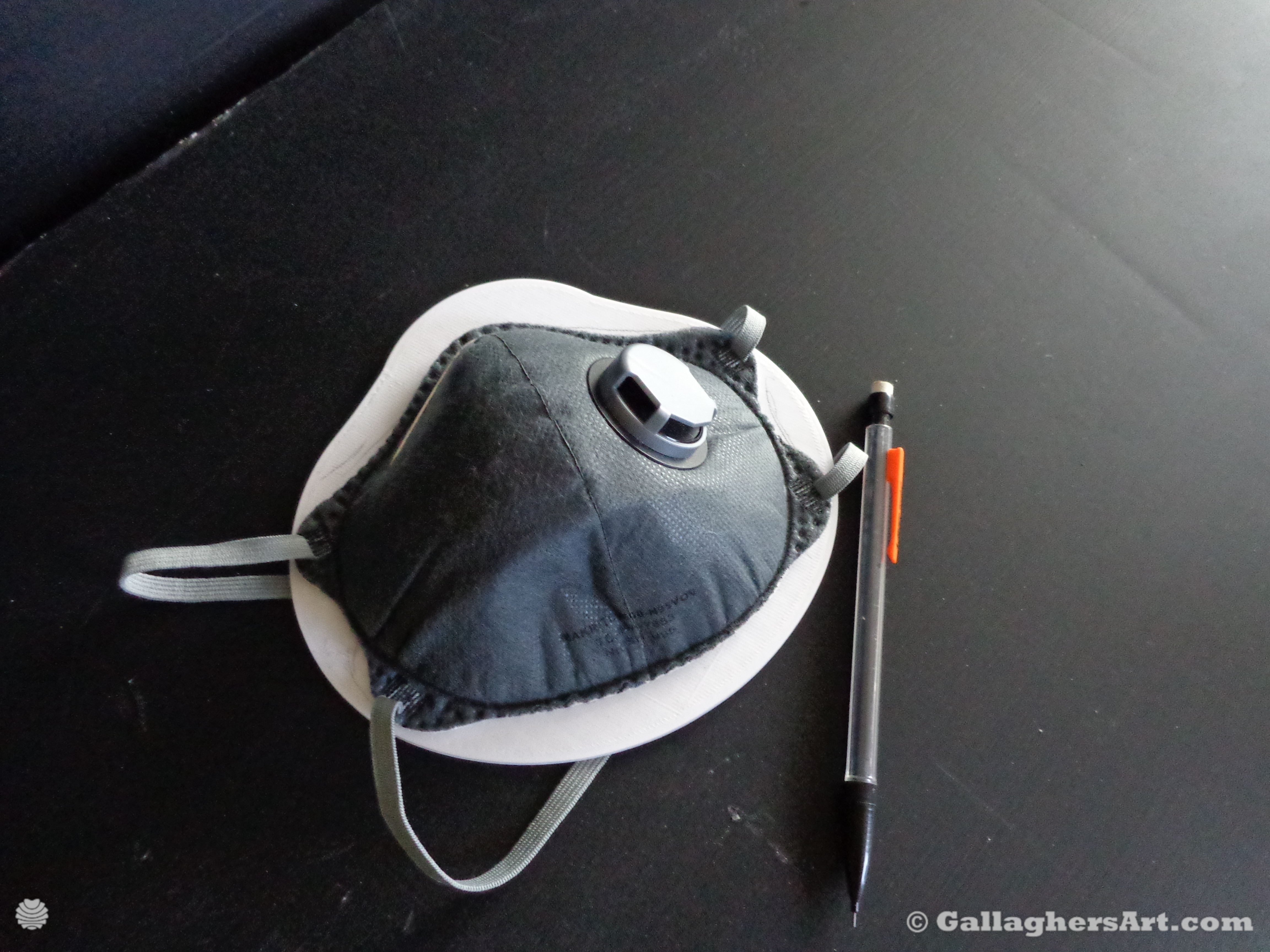 Gallaghersart airtight mask 003 dsc00344sm from Airtight adapters for Medical Masks and Face Respirators  - Place disposable mask on device and out line its shape on device with pencils while the mask is laying flat on the edges. This device is for masks that are formed to bend around mouth and nose.