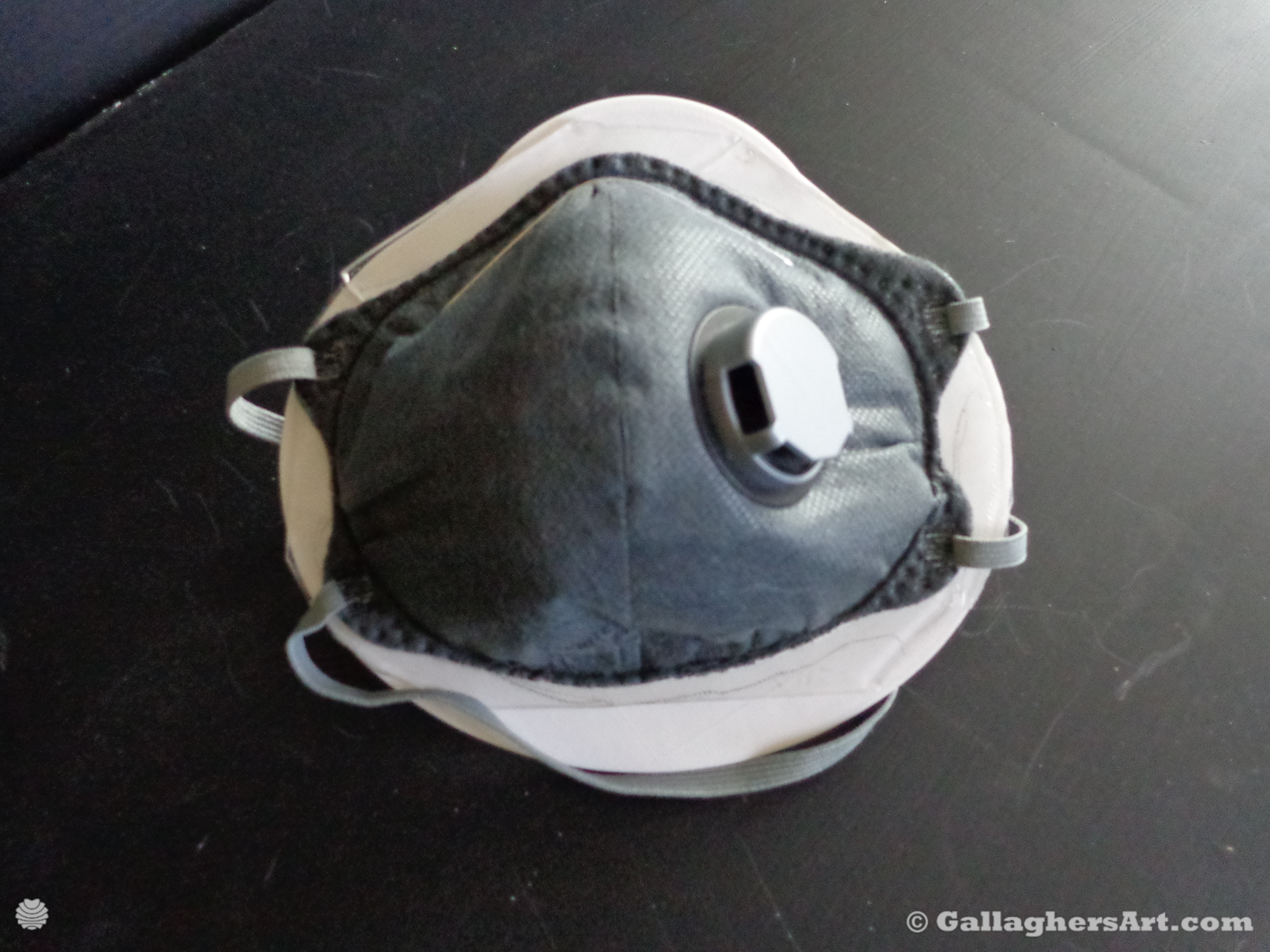 Gallaghersart airtight mask 003 dsc00348sm from Airtight adapters for Medical Masks and Face Respirators  - Place mask filter on double-sided tape already installed on device. Press mask firmly into tape.
Verify mask is held into place.
